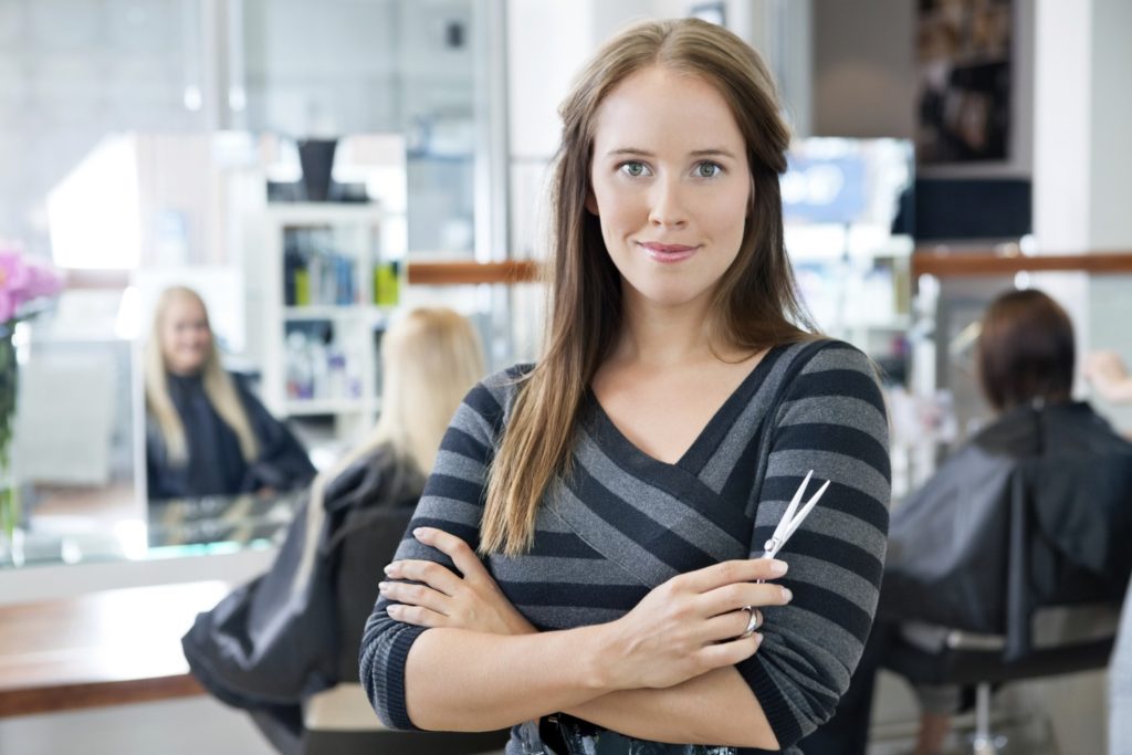 Smart Female Hairdresser Holding Scissor